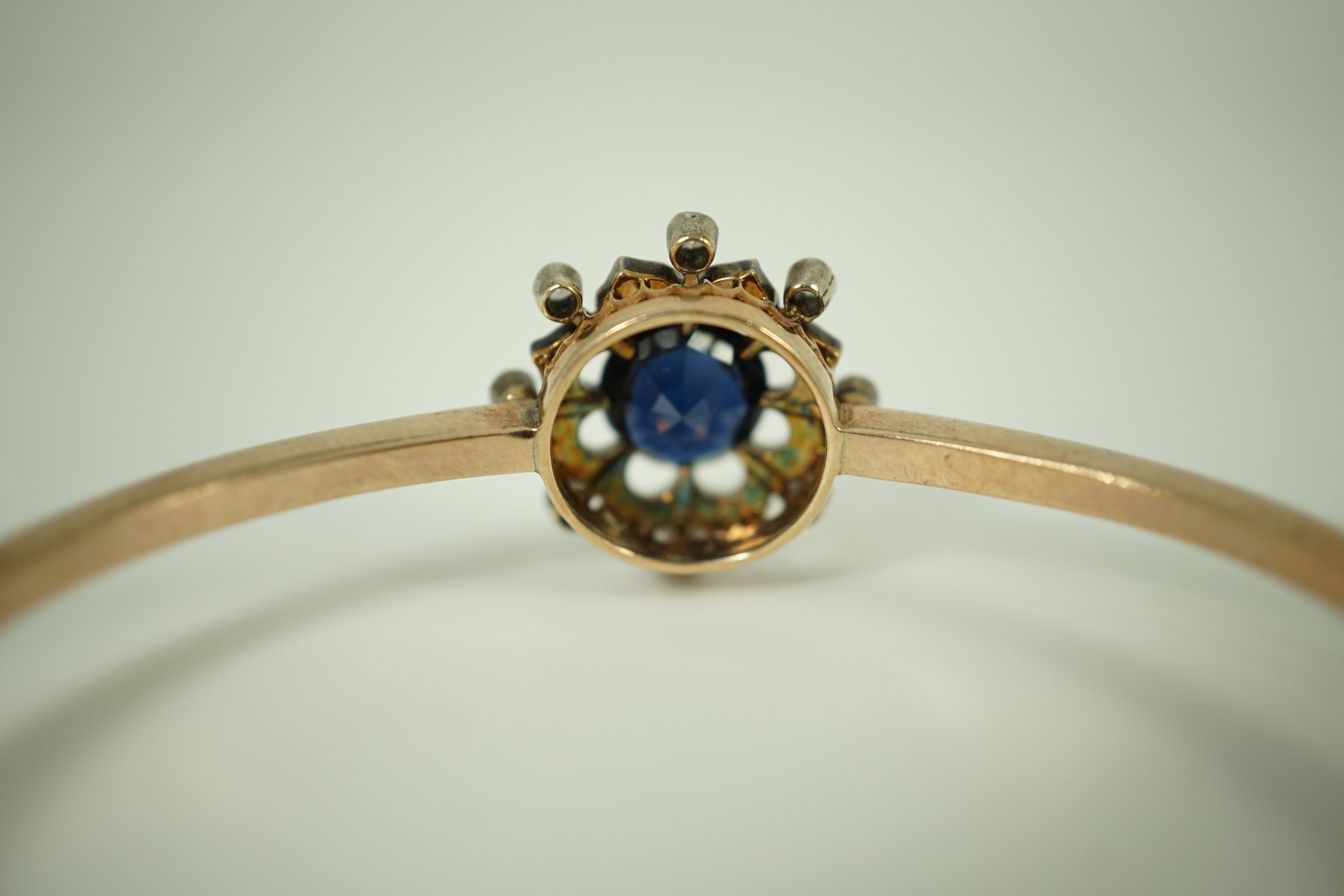 A Victorian gold, sapphire and diamond cluster set hinged bangle